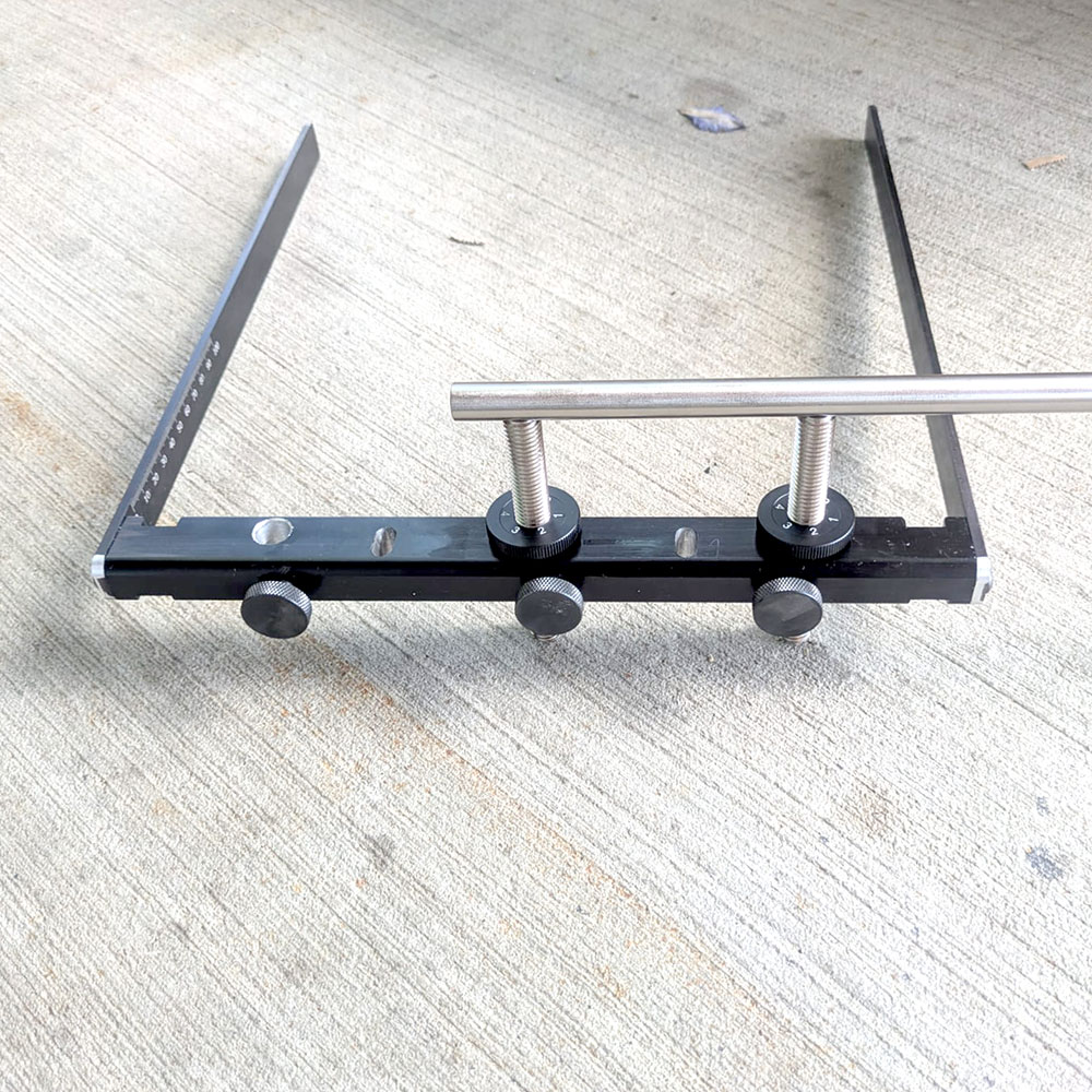 Front-mounted support bracket for use with Tradesman knife guide support rails, and Tormek US-105-style support rails. Includes two graduated arms and three thumb screws for support legs